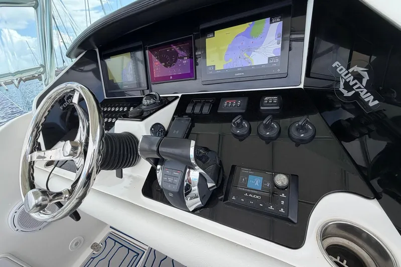  Yacht Photos Pics Control panel of a 2007 Fountain 38 Tournament Edition boat with navigation screens.