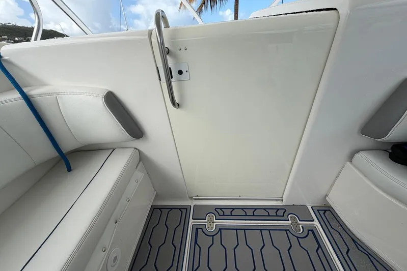  Yacht Photos Pics 2007 Fountain 38 Tournament Edition boat interior with white seating and patterned flooring.