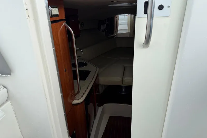  Yacht Photos Pics Interior view of 2007 Fountain 38 Tournament Edition boat cabin with kitchenette and seating area.