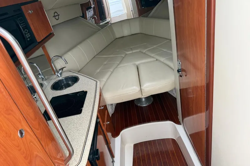  Yacht Photos Pics 2007 Fountain 38 Tournament Edition cabin with kitchenette and cozy seating area.