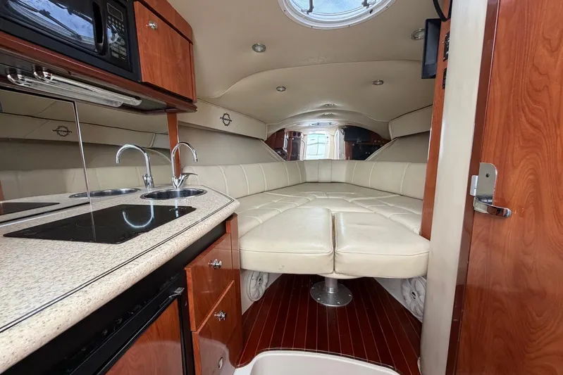  Yacht Photos Pics Luxurious interior of 2007 Fountain 38 Tournament Edition boat with kitchenette and seating area.