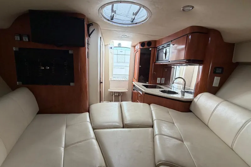  Yacht Photos Pics Luxurious interior of 2007 Fountain 38 Tournament Edition boat with leather seating and kitchenette.