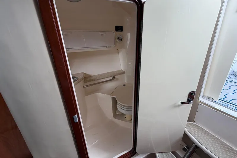  Yacht Photos Pics 2007 Fountain 38 Tournament Edition boat interior cabin with open door, showcasing compact design.