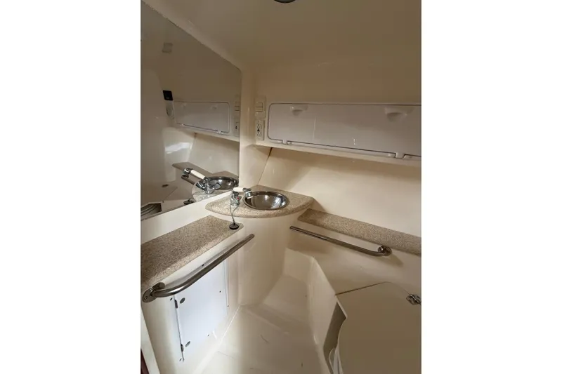  Yacht Photos Pics 2007 Fountain 38 Tournament Edition boat interior with sink and storage compartments.