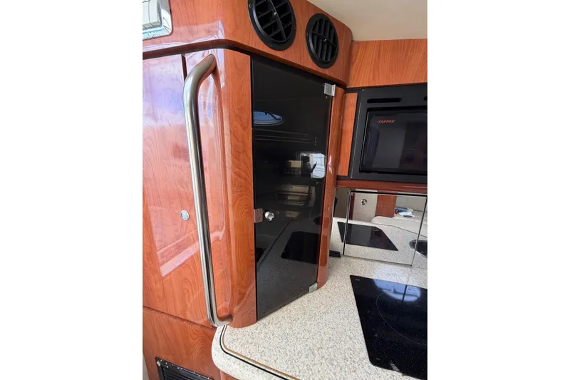  Yacht Photos Pics 2007 Fountain 38 Tournament Edition boat interior with wood finish and modern appliances.