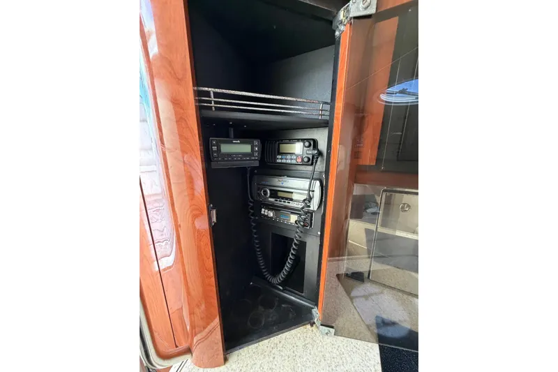  Yacht Photos Pics 2007 Fountain 38 Tournament Edition boat radio equipment in wooden cabinet.