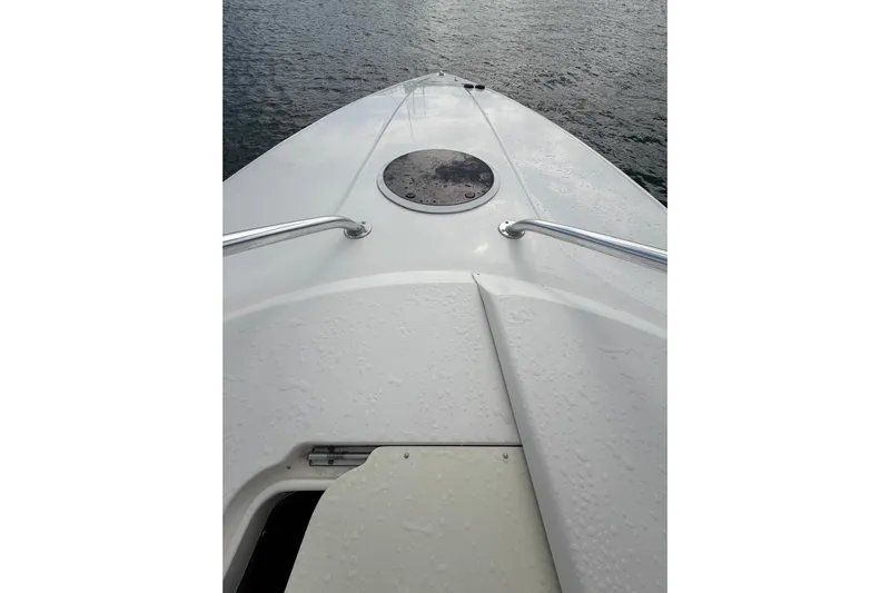  Yacht Photos Pics 2007 Fountain 38 Tournament Edition boat deck with water droplets, overlooking the sea.