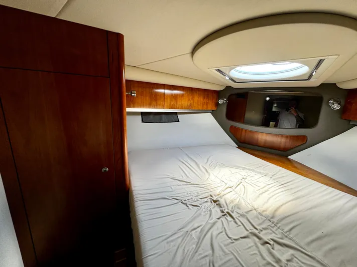  Yacht Photos Pics Interior cabin of 2008 Cruisers Yachts 390 Sports Coupe with bed and wooden cabinetry.