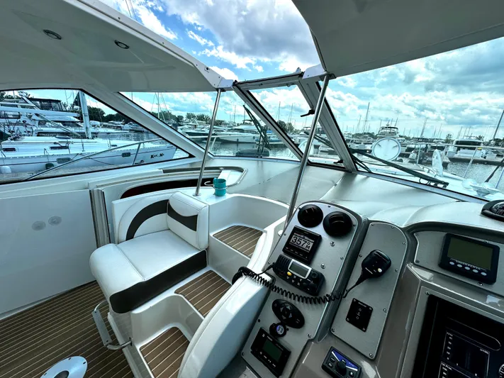  Yacht Photos Pics 2008 Cruisers Yachts 390 Sports Coupe cockpit with modern controls and marina view.