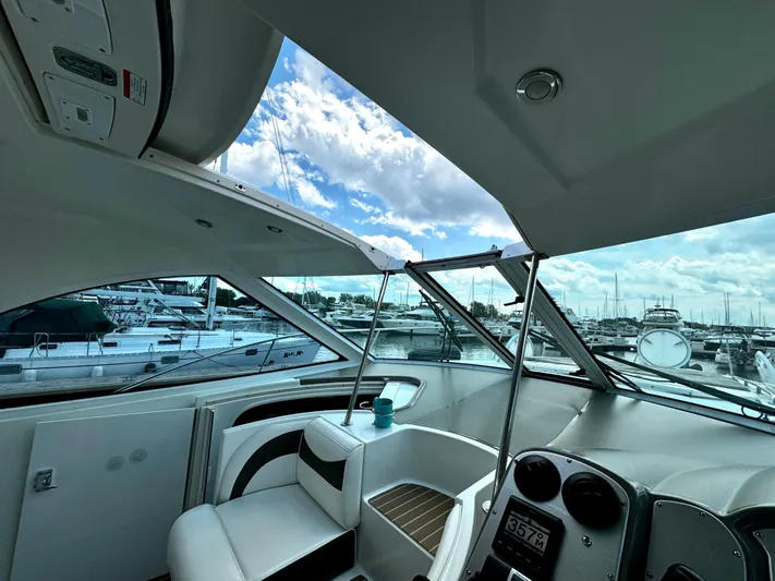  Yacht Photos Pics Interior view of 2008 Cruisers Yachts 390 Sports Coupe at marina, showcasing helm and seating.
