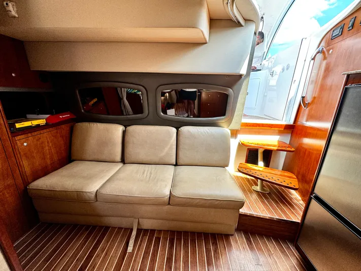  Yacht Photos Pics Interior of 2008 Cruisers Yachts 390 Sports Coupe with beige sofa and wooden accents.