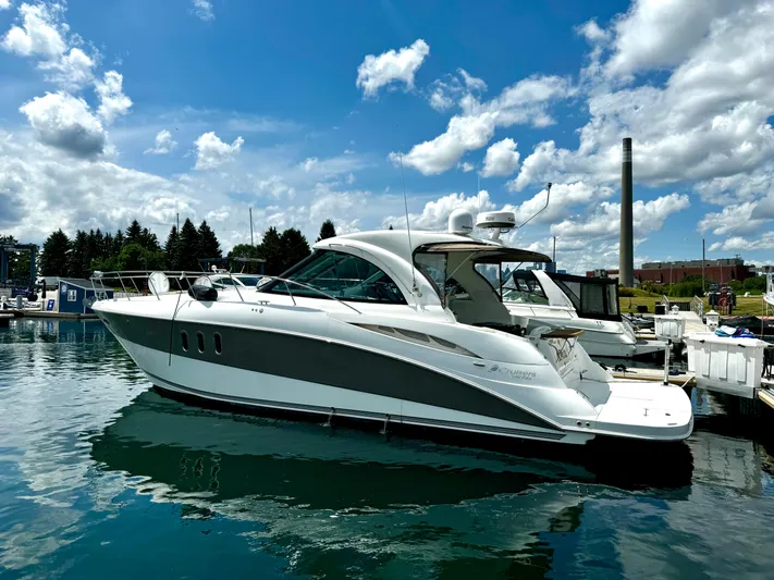  Yacht Photos Pics 2008 Cruisers Yachts 390 Sports Coupe docked under a blue sky.