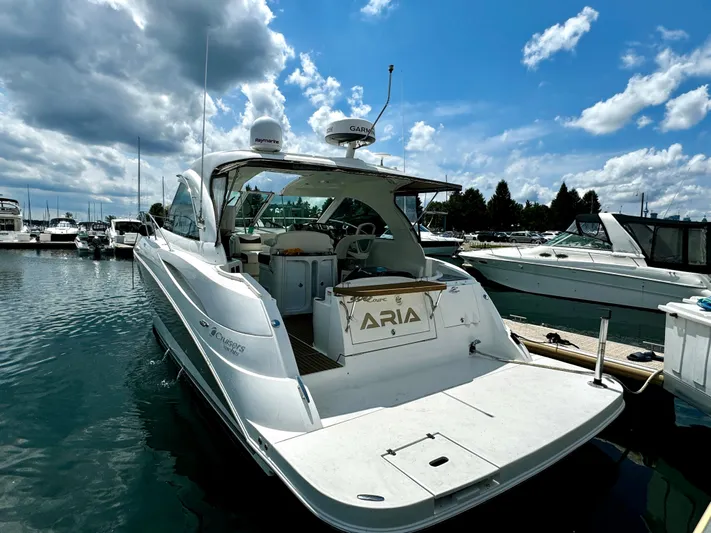  Yacht Photos Pics 2008 Cruisers Yachts 390 Sports Coupe docked at marina under blue sky.