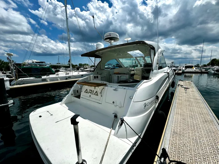  Yacht Photos Pics 2008 Cruisers Yachts 390 Sports Coupe docked at marina under cloudy sky.