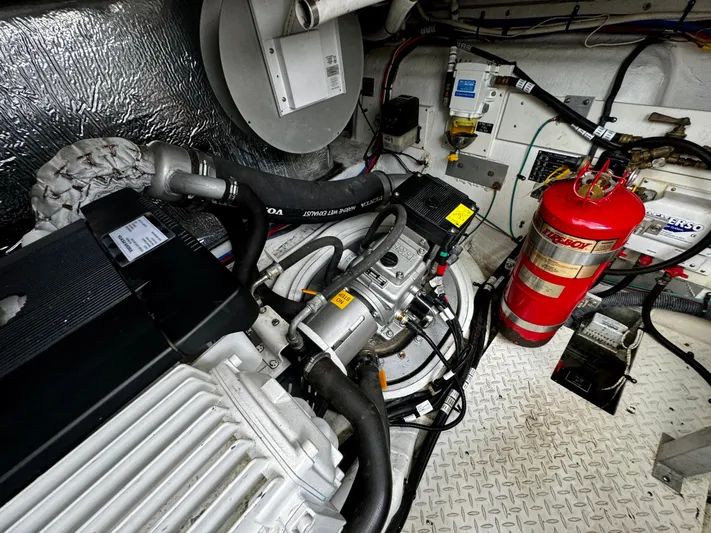  Yacht Photos Pics Engine room of a 2008 Cruisers Yachts 390 Sports Coupe with fire extinguisher and mechanical components.