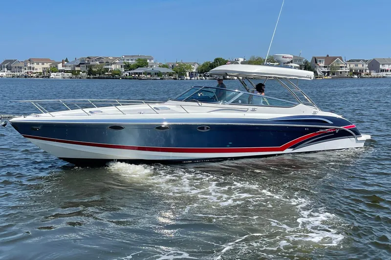  Yacht Photos Pics 2017 Formula 370 Super Sport boat cruising on a sunny day near waterfront homes.