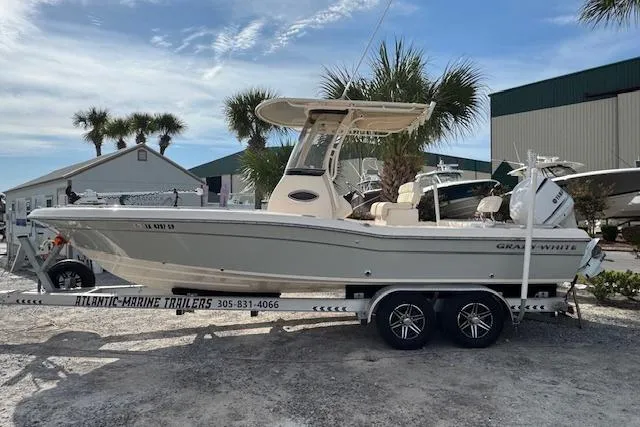  Yacht Photos Pics 2021 Grady-White 251 Coastal Explorer boat on trailer, parked outdoors near palm trees.