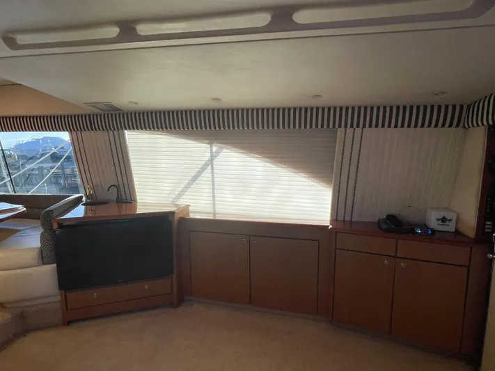 End Game Yacht Photos Pics Interior of 2001 Ocean Yachts 56 Super Sport with wood cabinets and striped curtains.