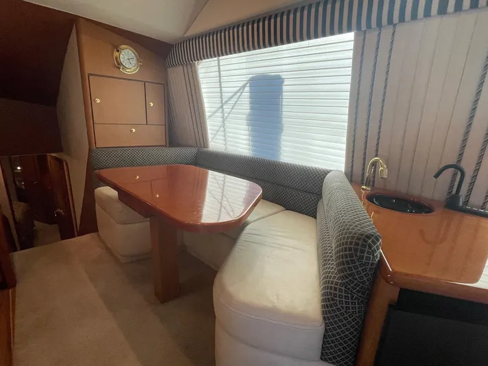 End Game Yacht Photos Pics Interior of 2001 Ocean Yachts 56 Super Sport with dining area and kitchenette.