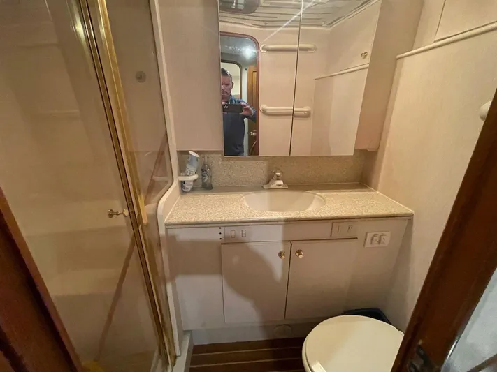 End Game Yacht Photos Pics Bathroom interior of 2001 Ocean Yachts 56 Super Sport with shower, sink, and toilet.