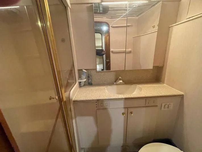 End Game Yacht Photos Pics Bathroom interior of 2001 Ocean Yachts 56 Super Sport with sink and shower.
