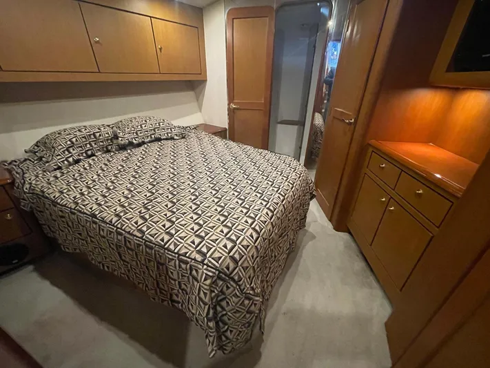 End Game Yacht Photos Pics Luxurious bedroom interior of 2001 Ocean Yachts 56 Super Sport with patterned bedding.