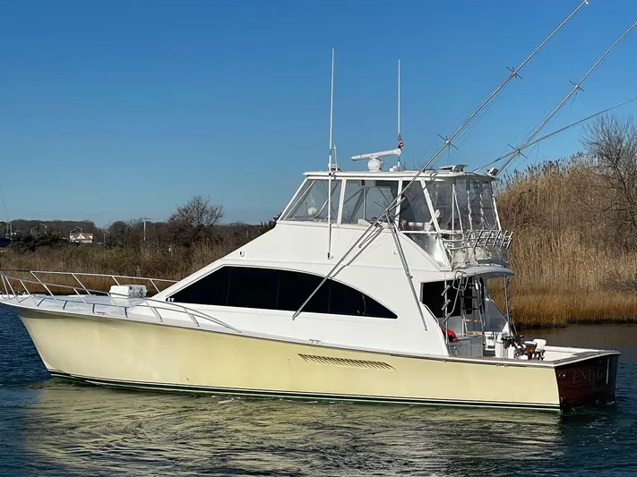 End Game Yacht Photos Pics 2001 Ocean Yachts 56 Super Sport boat on calm water, side view.