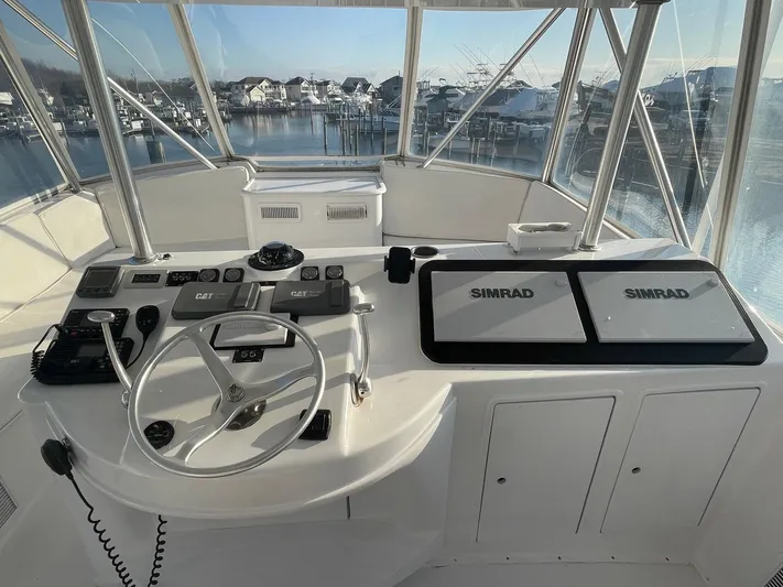 End Game Yacht Photos Pics Cockpit of 2001 Ocean Yachts 56 Super Sport with steering wheel and navigation equipment.