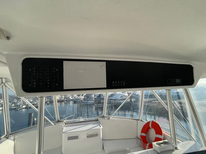 End Game Yacht Photos Pics 2001 Ocean Yachts 56 Super Sport yacht interior with control panel and marina view.