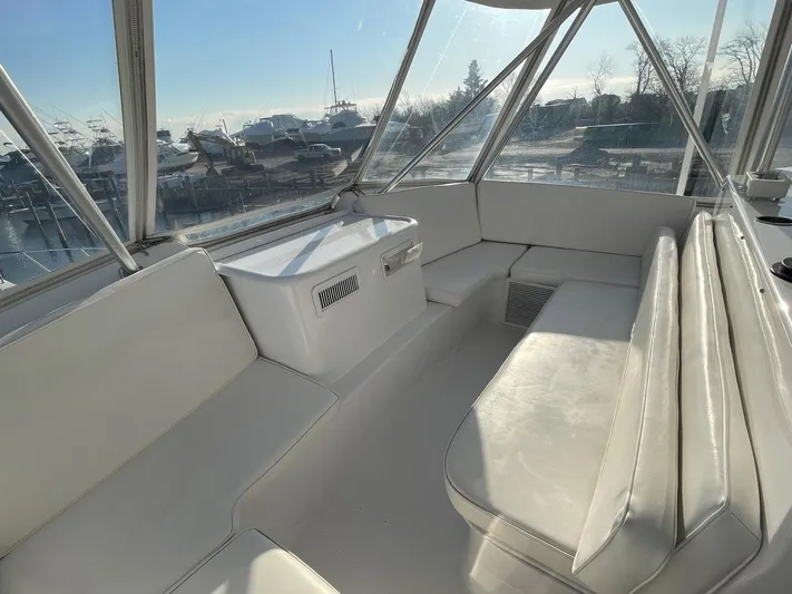 End Game Yacht Photos Pics 2001 Ocean Yachts 56 Super Sport interior with white seating and panoramic windows.