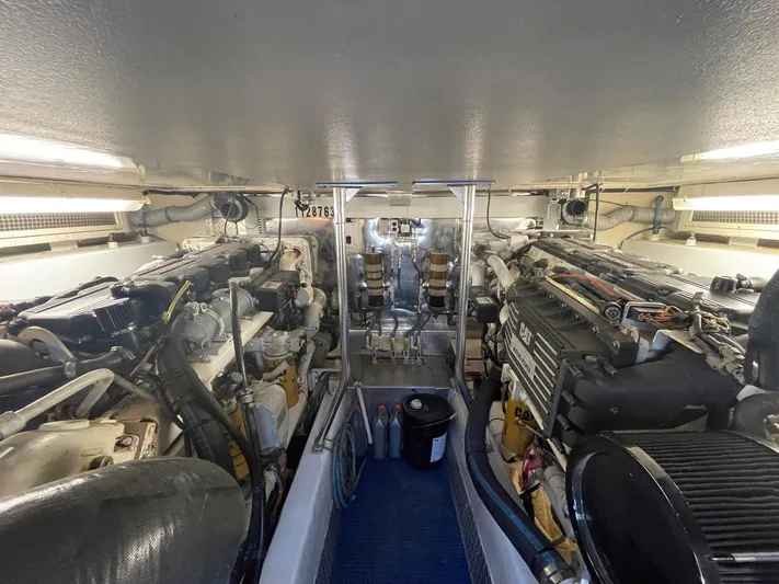 End Game Yacht Photos Pics Engine room of 2001 Ocean Yachts 56 Super Sport, showcasing dual engines and mechanical components.