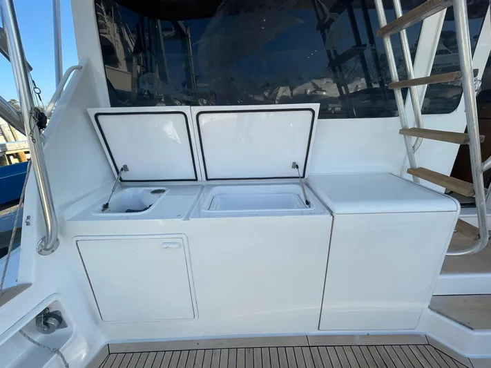 End Game Yacht Photos Pics 2001 Ocean Yachts 56 Super Sport yacht deck with sink and storage compartments.