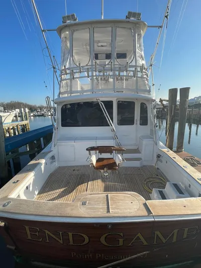 End Game Yacht Photos Pics 2001 Ocean Yachts 56 Super Sport docked, rear view with fishing equipment.