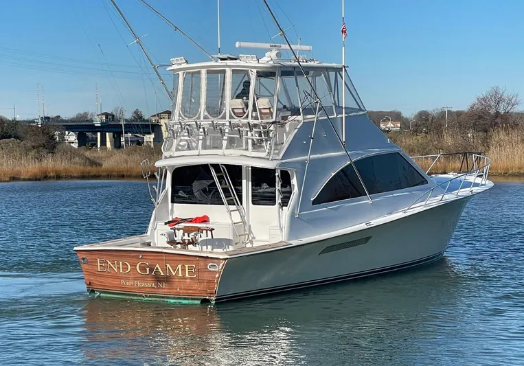 End Game Yacht Photos Pics 2001 Ocean Yachts 56 Super Sport boat on water, named "End Game," with clear blue sky.
