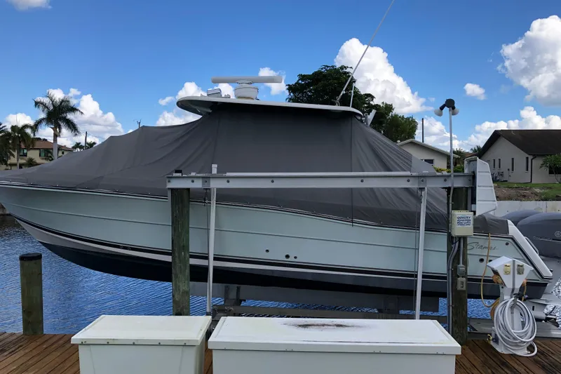  Yacht Photos Pics 2016 Stamas TARPON 326 boat covered at dock, under a clear blue sky.