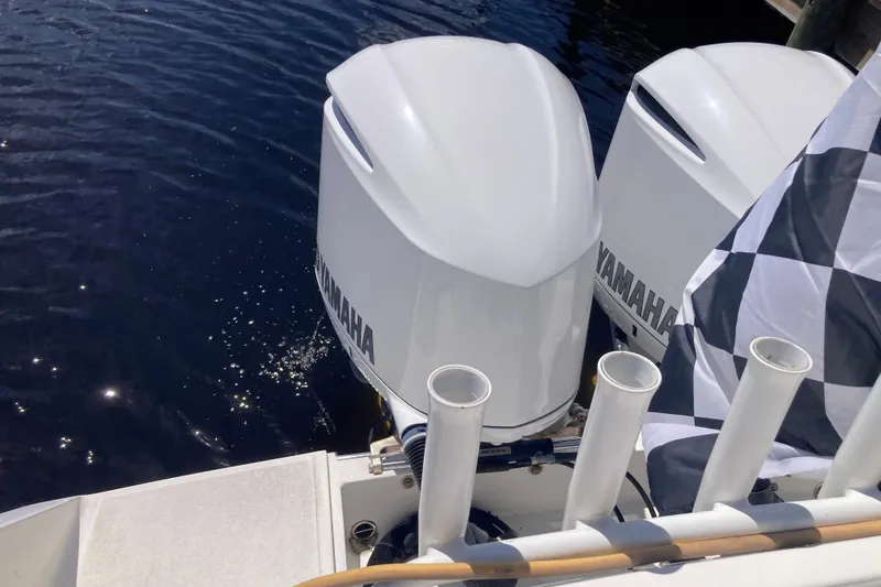  Yacht Photos Pics Twin Yamaha outboard motors on a 2016 Tarpon 326 boat, docked by the water.