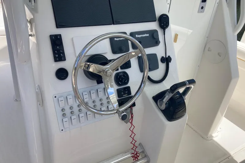  Yacht Photos Pics 2016 Tarpon 326 boat dashboard with steering wheel and control panel.