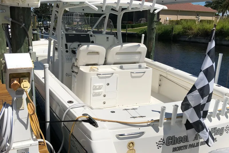 Yacht Photos Pics 2016 Tarpon 326 boat docked, featuring a checkered flag and dual seating.