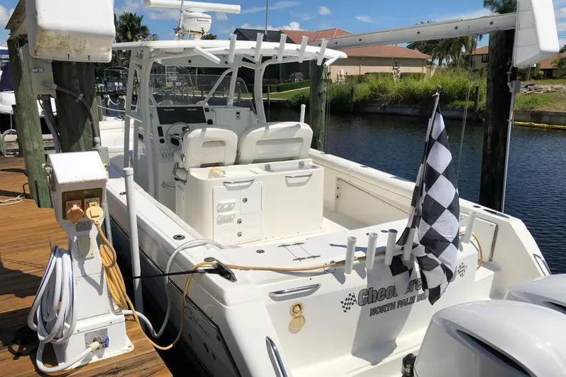 Yacht Photos Pics 2016 Tarpon 326 boat docked, featuring a checkered flag and modern amenities.
