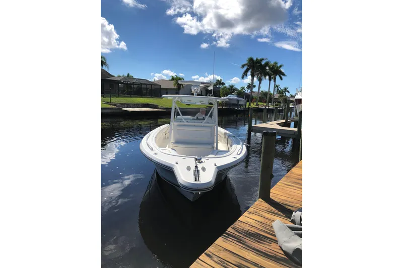  Yacht Photos Pics 2016 Tarpon 326 boat docked on a sunny day with palm trees in the background.