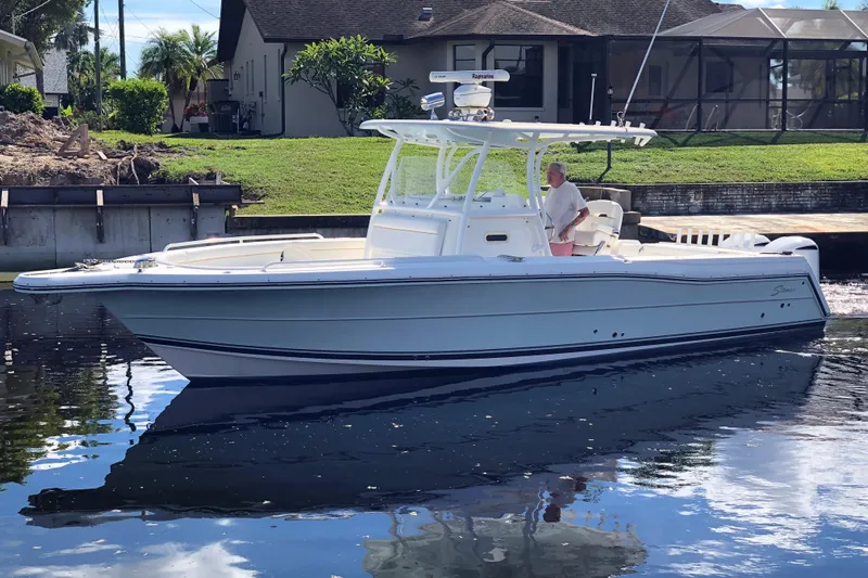  Yacht Photos Pics 2016 Tarpon 326 boat on calm water near a residential area.