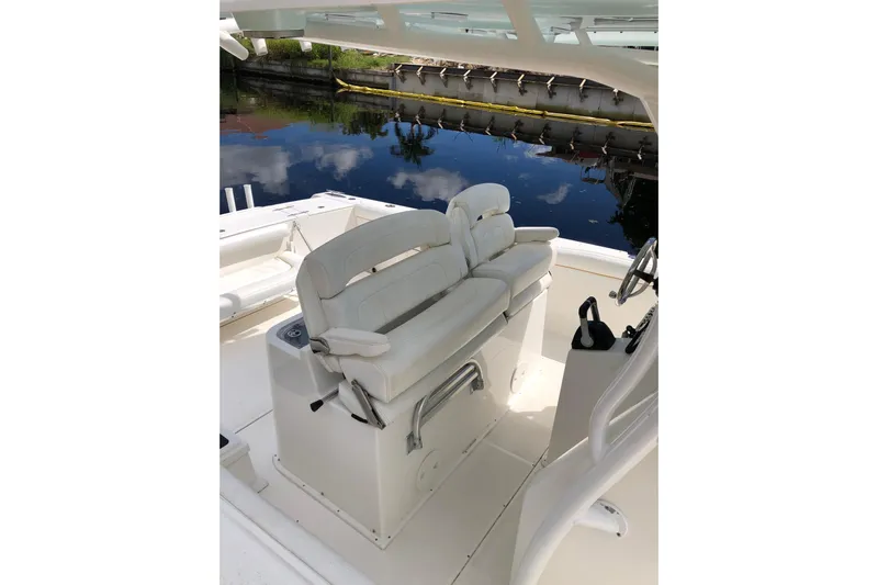  Yacht Photos Pics 2016 Tarpon 326 boat interior with white seating and steering wheel.