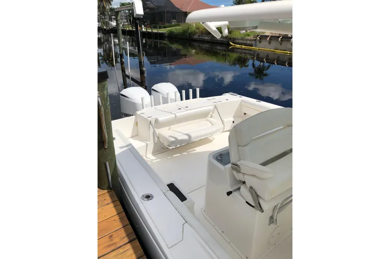  Yacht Photos Pics 2016 Tarpon 326 boat with dual Yamaha engines docked by a calm canal.
