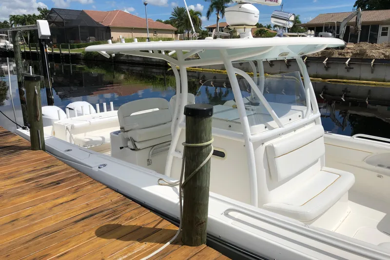  Yacht Photos Pics 2016 Tarpon 326 boat docked, featuring a sleek white design and spacious seating.