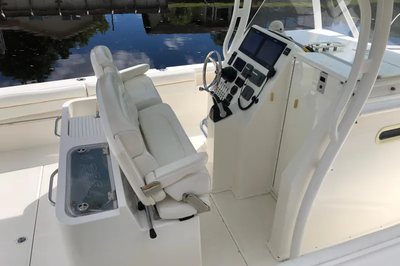  Yacht Photos Pics 2016 Tarpon 326 boat interior with helm, seating, and control panel by the water.