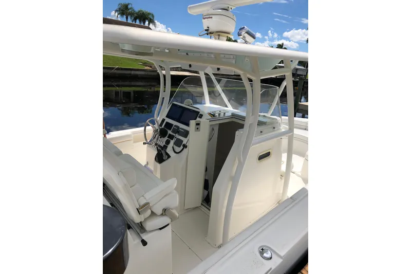  Yacht Photos Pics 2016 Tarpon 326 boat cockpit with steering wheel, controls, and navigation equipment.