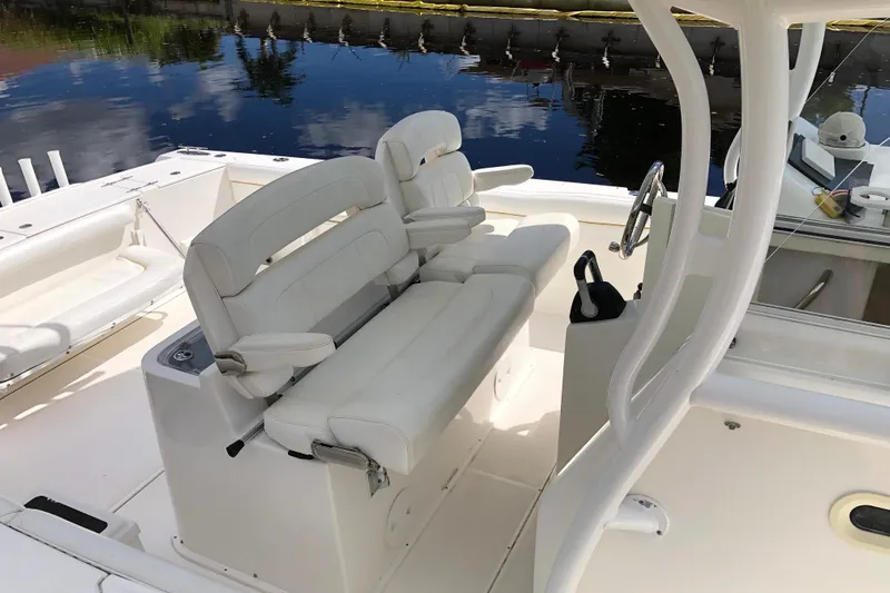  Yacht Photos Pics 2016 Tarpon 326 boat interior with white cushioned seating and steering wheel.