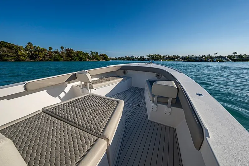  Yacht Photos Pics 2021 Albury Brothers 33 boat interior with cushioned seating on calm water.