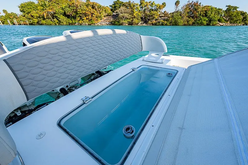  Yacht Photos Pics 2021 Albury Brothers 33 boat with open storage compartment on turquoise water.