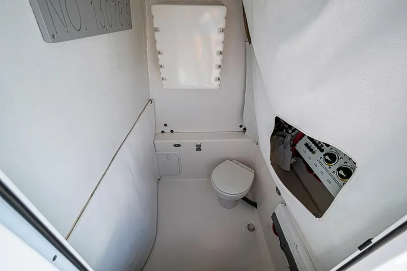  Yacht Photos Pics 2021 Albury Brothers 33 boat interior with compact bathroom and control panel.